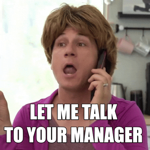 A comedian dressed as blonde woman asking to talk to the manager. 